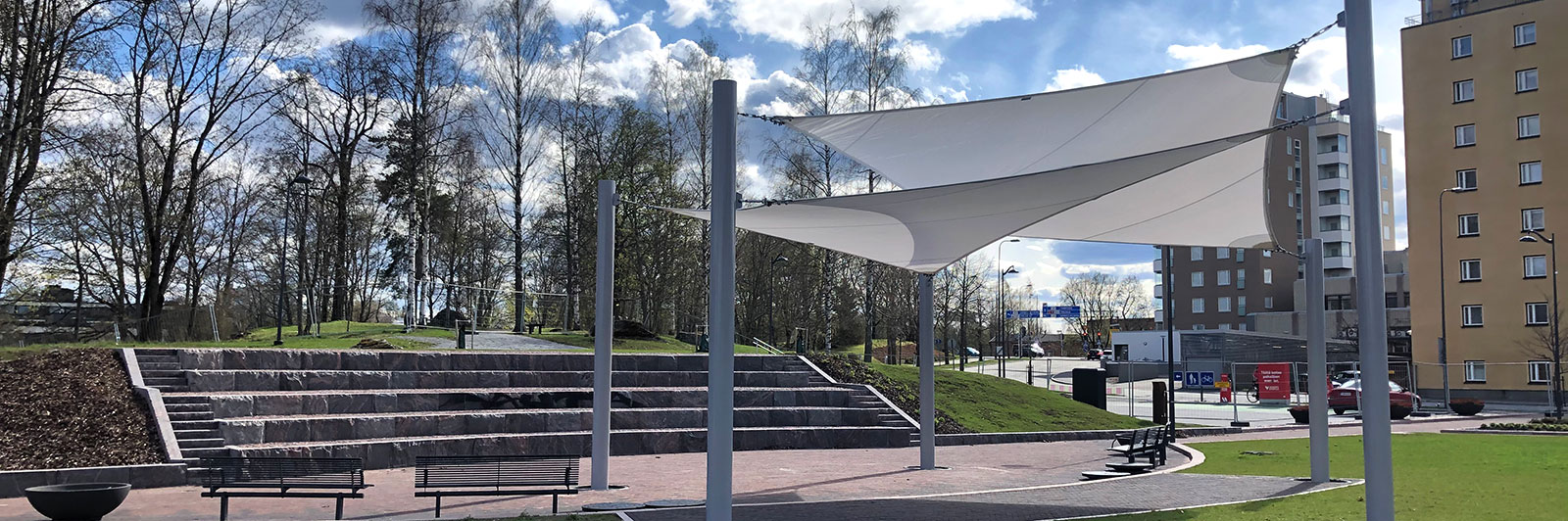 Shade structures like canopies, in public environments, providing shade and UV protection.